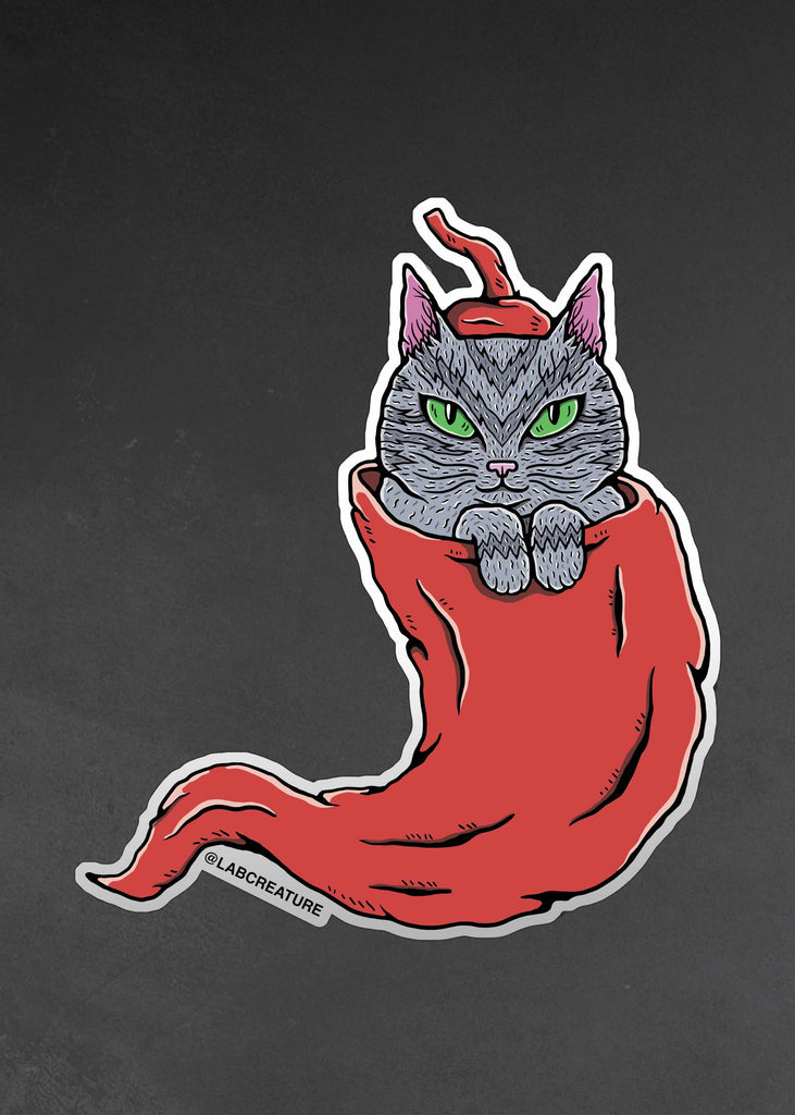 Photo of a vinyl sticker featuring an illustration of a cat inside of a red chile